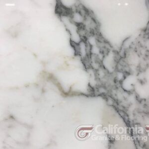White marble slab with gray and tan veining.