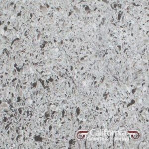 Gray quartz countertop with speckled dark and light flecks.