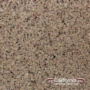 Close-up of brown granite countertop with small black and brown flecks throughout.
