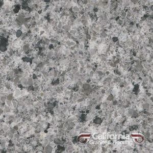 Close-up view of a speckled grey granite countertop with small dark specks throughout.