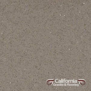 Gray quartz countertop with small flecks. California Granite & Flooring logo.