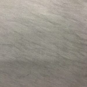 Light gray, textured surface with subtle diagonal streaks, possibly fabric or stone.
