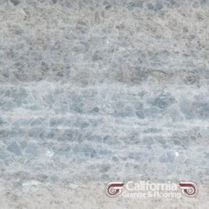 Blue and white marble slab with veining patterns, California Granite & Flooring logo at bottom.