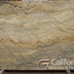 Close-up of a large slab of granite with wavy, swirling patterns in gold, brown, and gray tones.
