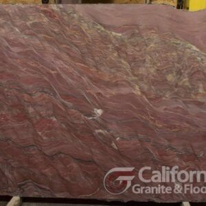 Red and beige swirled granite slab with the California Granite & Floor logo.