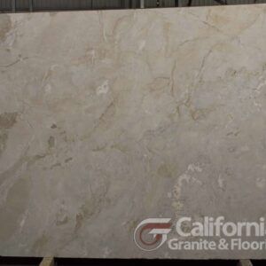 Large slab of creamy beige marble with subtle veining, displayed by California Granite & Floors.