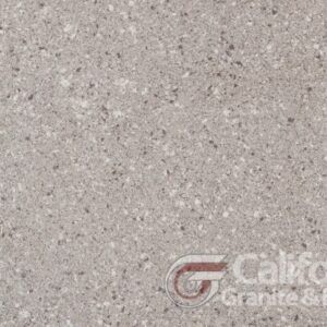 Gray speckled quartz countertop with black and white flecks.