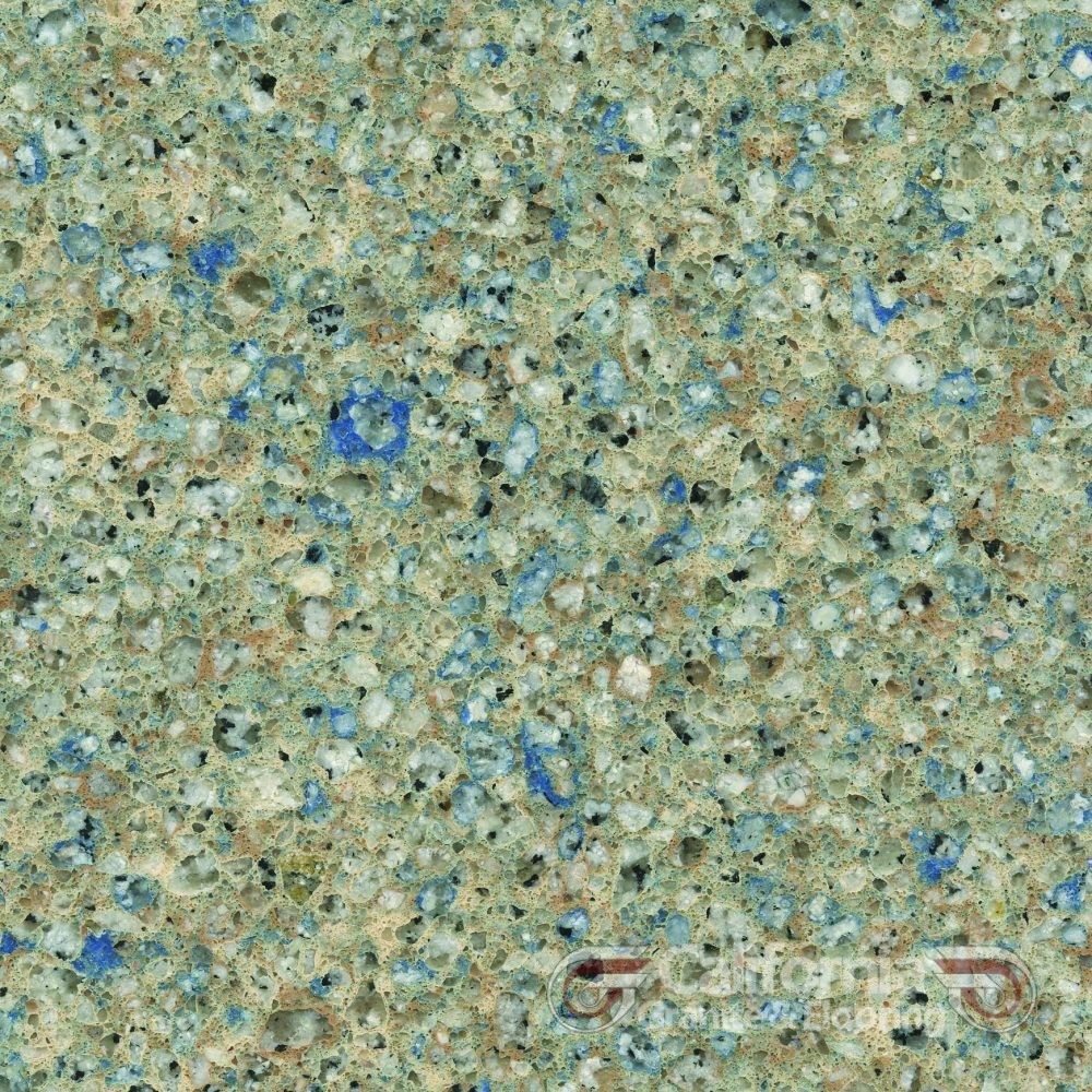 Green speckled countertop with blue and white flecks.