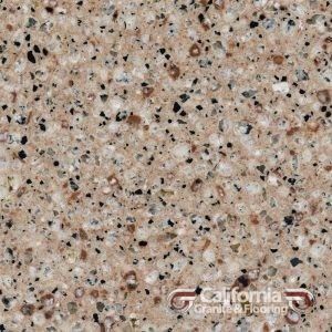 Close-up of light beige granite countertop with black, brown, and gray flecks.