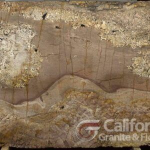 A large slab of granite in earthy tones: brown, beige, and gold, with unique veining patterns and textures. The logo