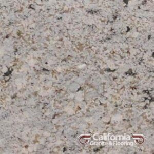 Close-up of granite countertop with speckled pattern in shades of white, gray, and tan with black flecks.