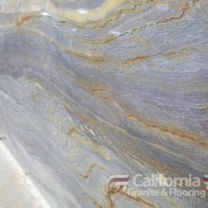 Swirling blue, gray, and gold marble surface. Natural stone pattern, likely for countertops or flooring.