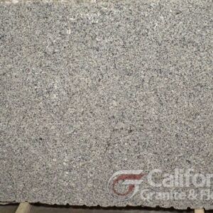 Gray granite slab with a speckled pattern, displayed for sale.