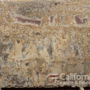 Close-up of a granite slab with mottled beige, gray, and hints of purple patterns. The slab's surface shows varied veining and texture.