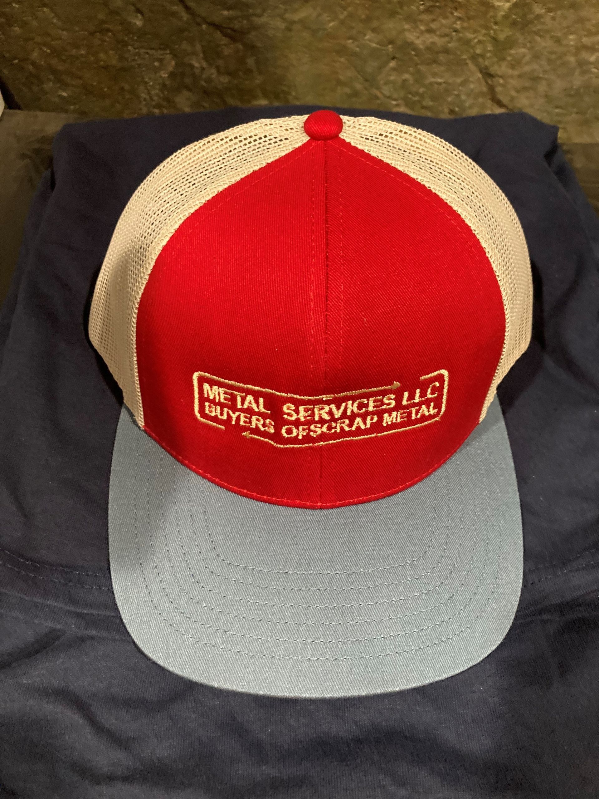 A red hat that says metal services llc on it