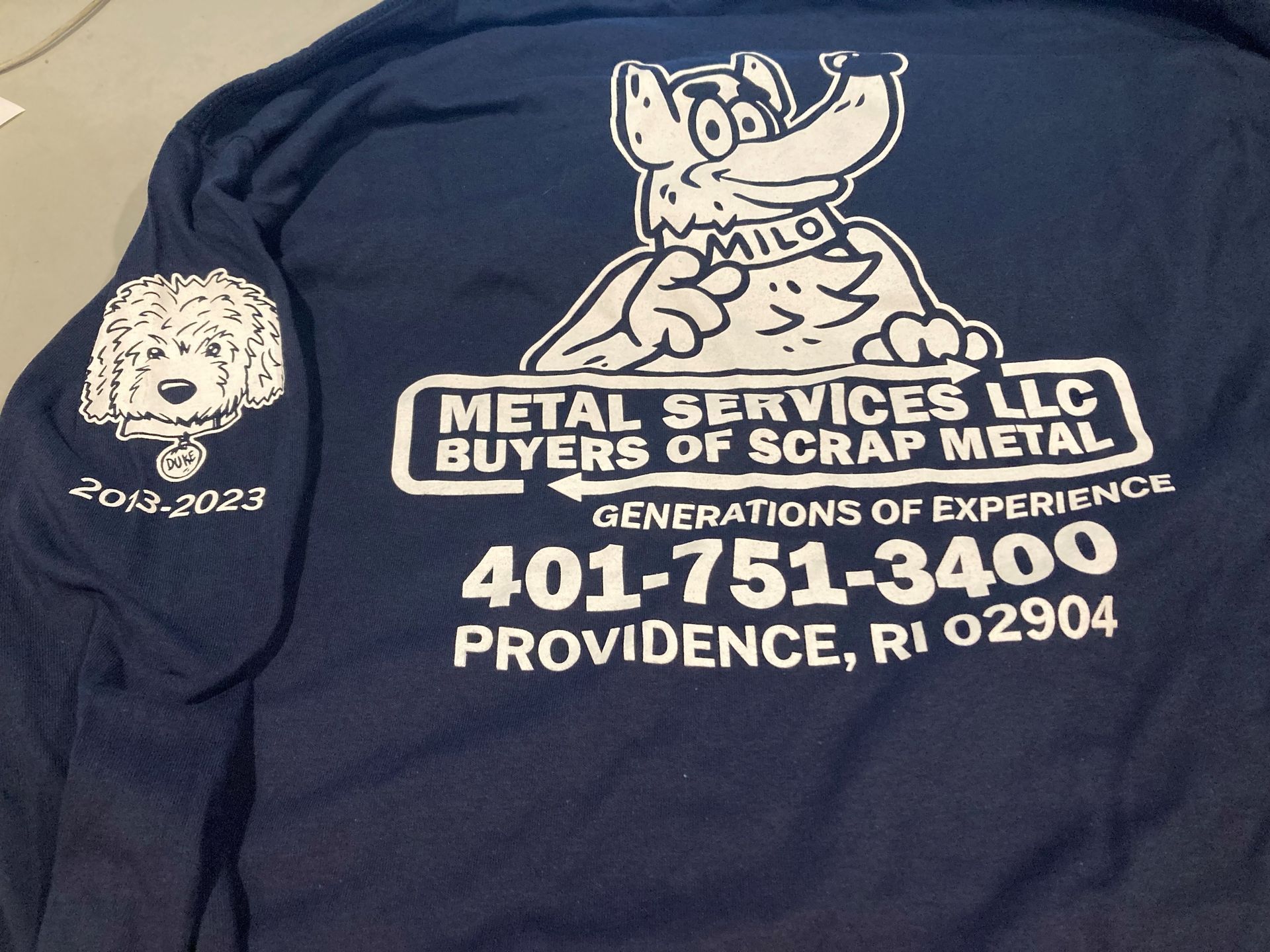 A blue shirt says metal services llc buyers of scrap metal