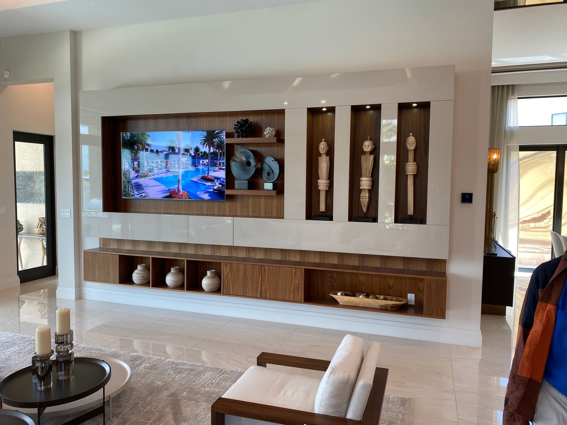 a living room with a large flat screen tv on the wall .