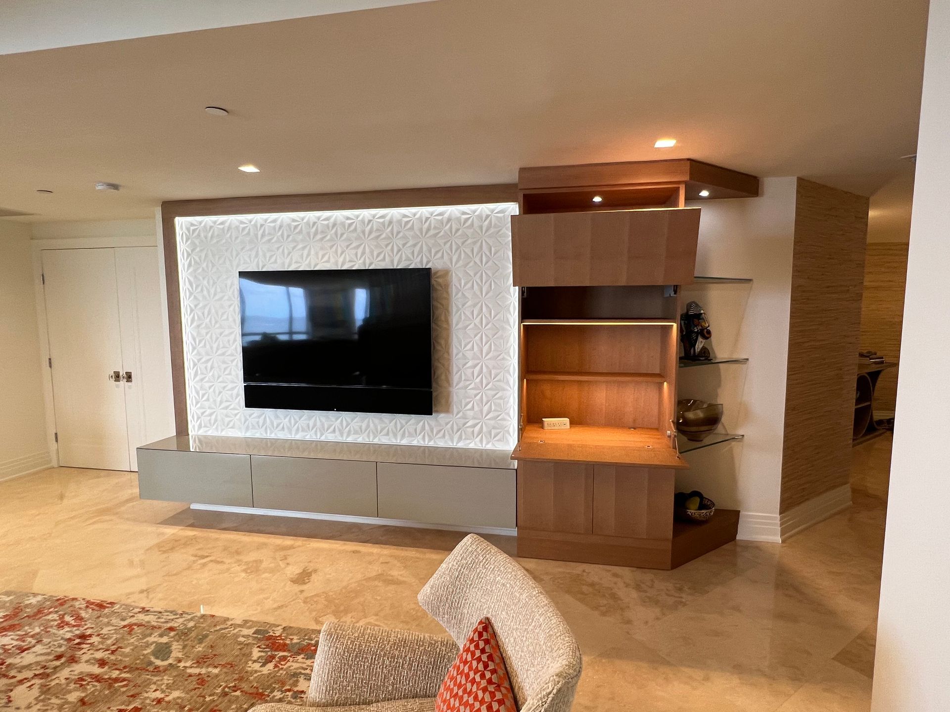 a living room with a large flat screen tv on the wall .