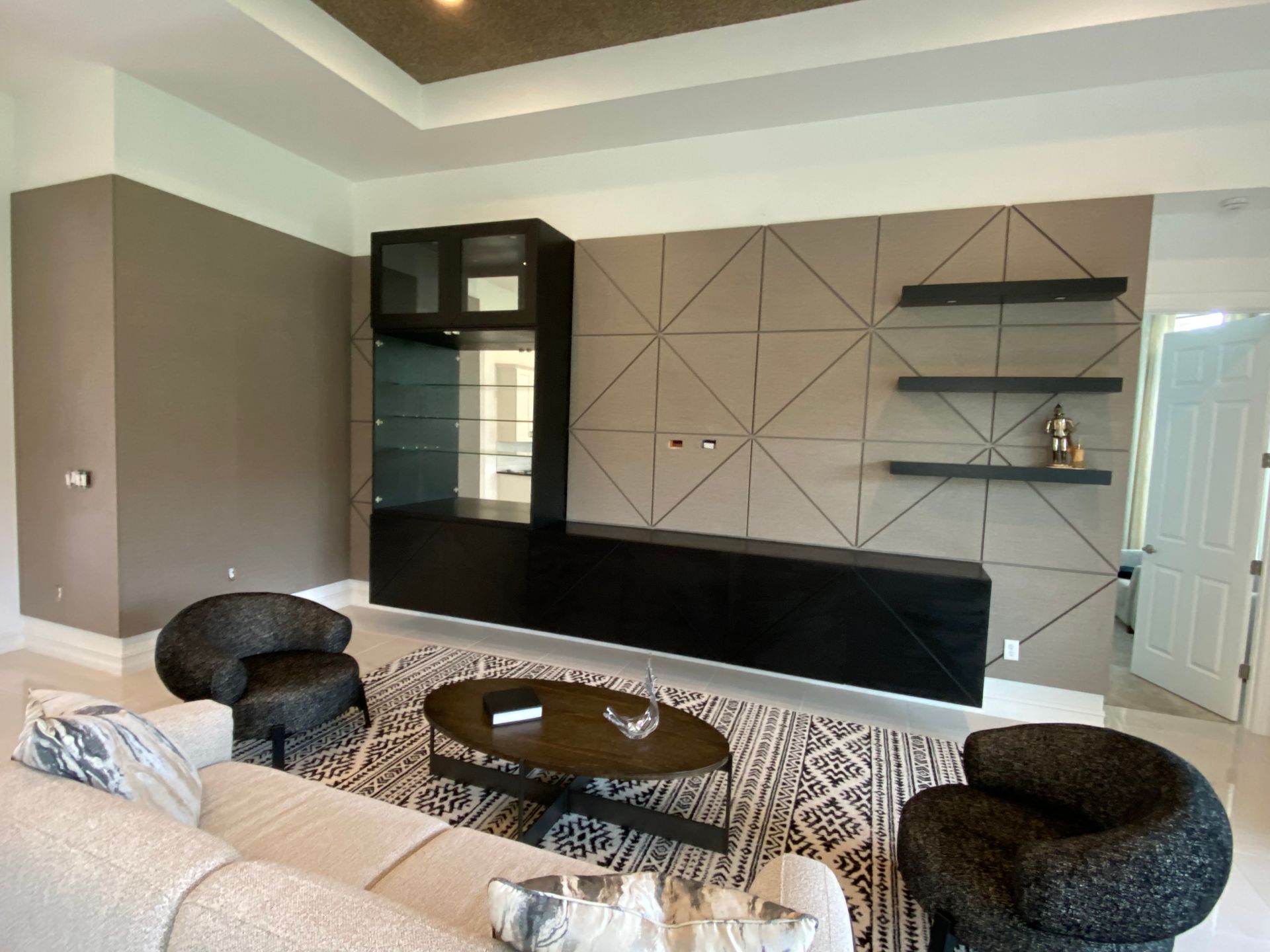 a living room with a couch, chairs, and a coffee table