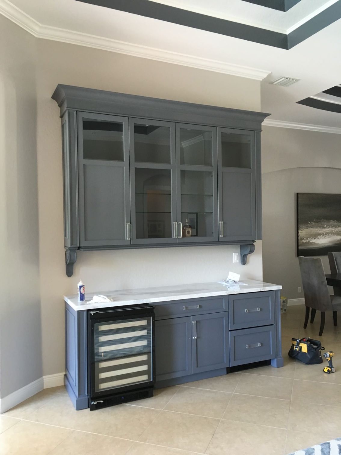 a kitchen with gray cabinets