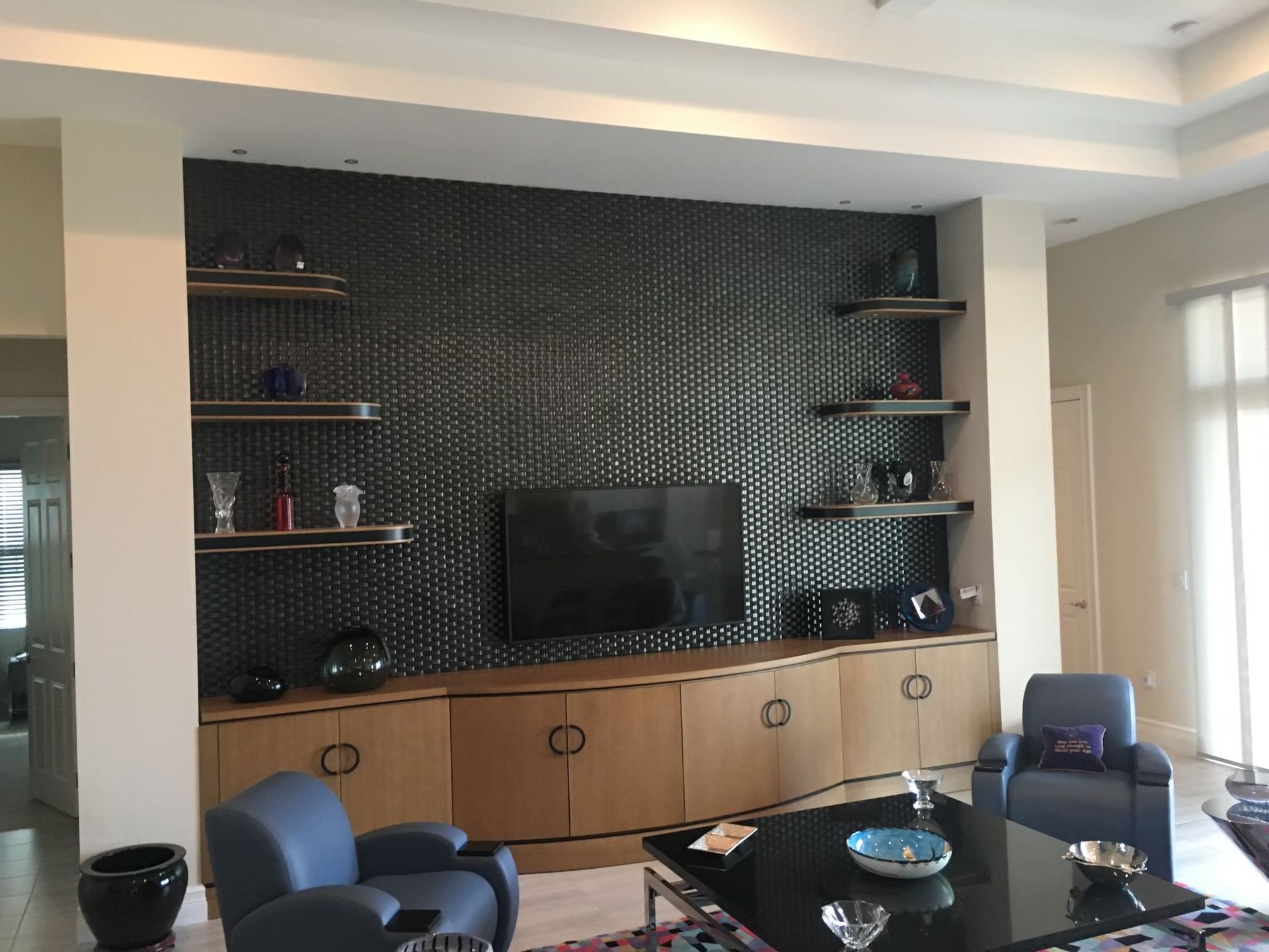 a living room with a flat-screen tv on the wall