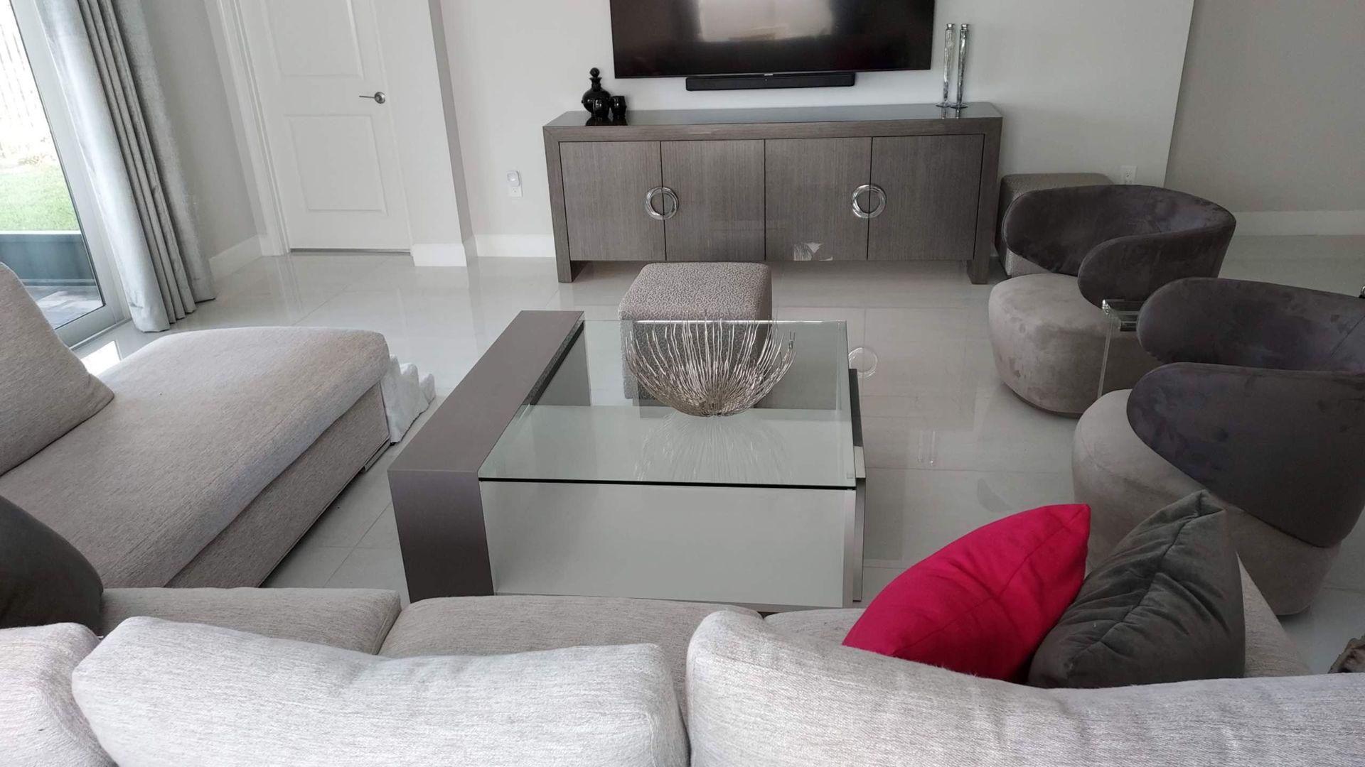 a living room with a couch, chairs, and coffee table