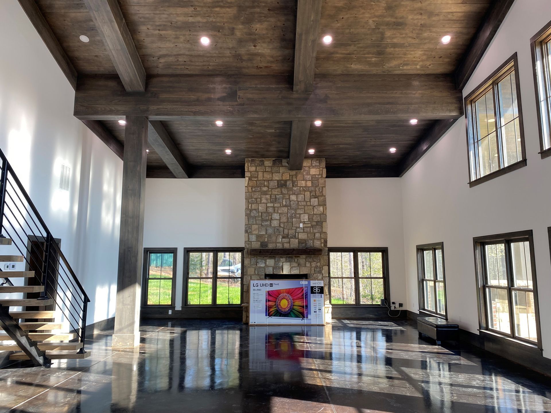 A large room with a fireplace and a lot of windows