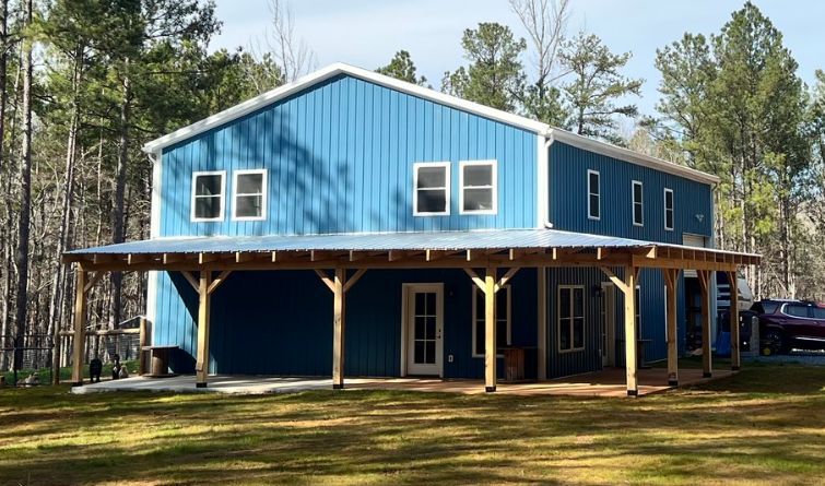 A large blue house with a porch