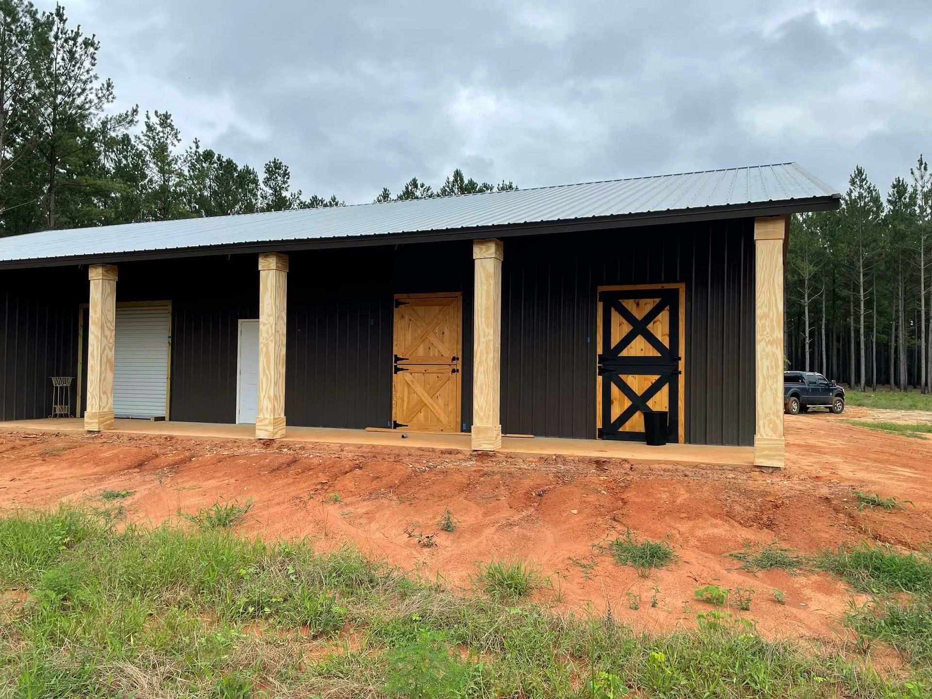 A black barn with a wooden door