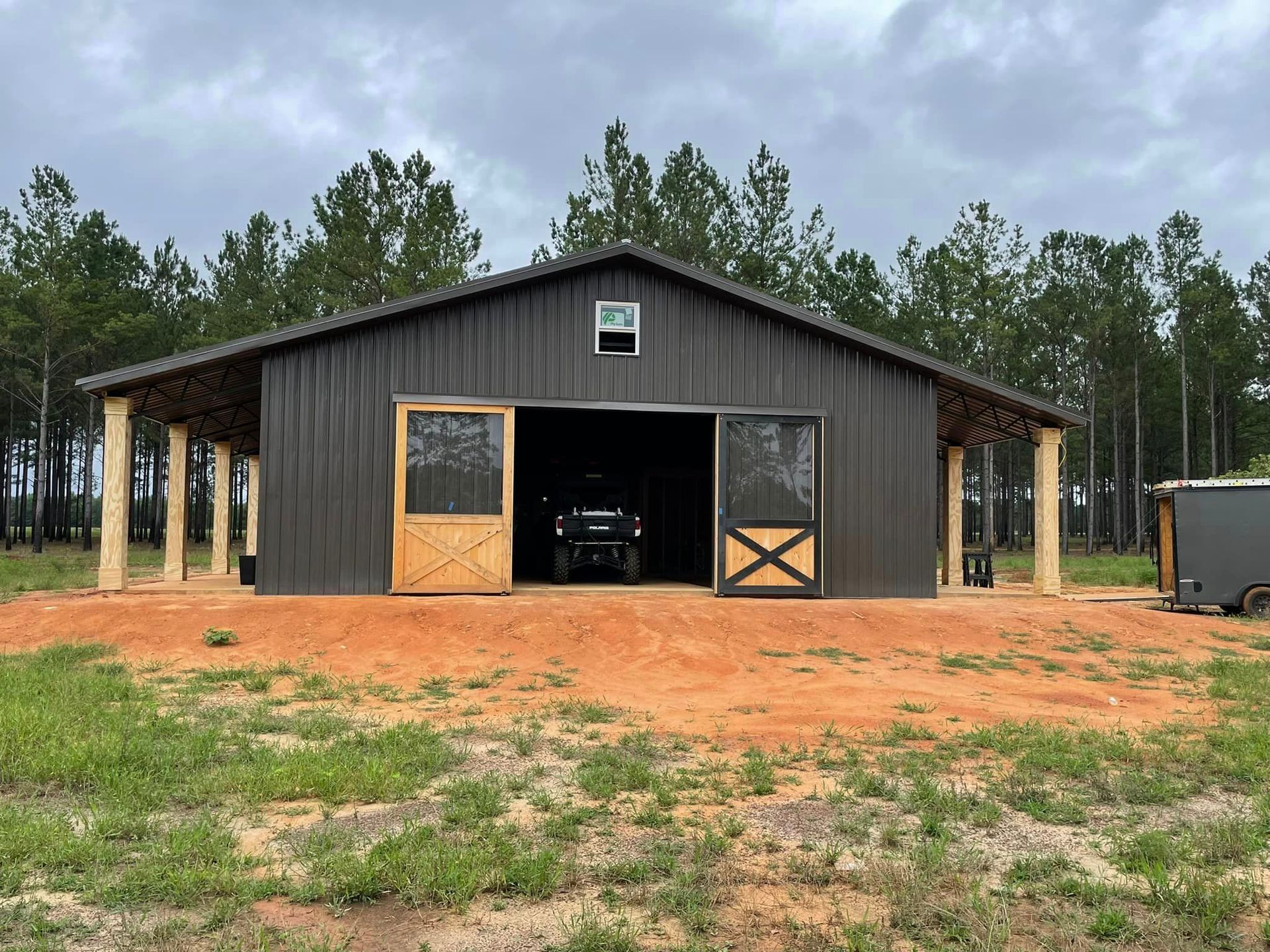 a truck is parked in a barn with the door open