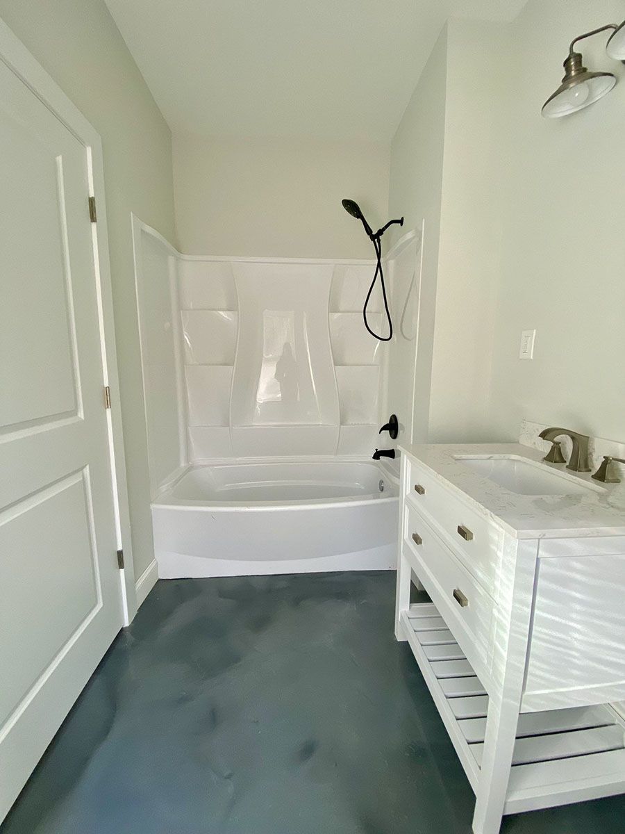 A bathroom with a bathtub, sink, and shower