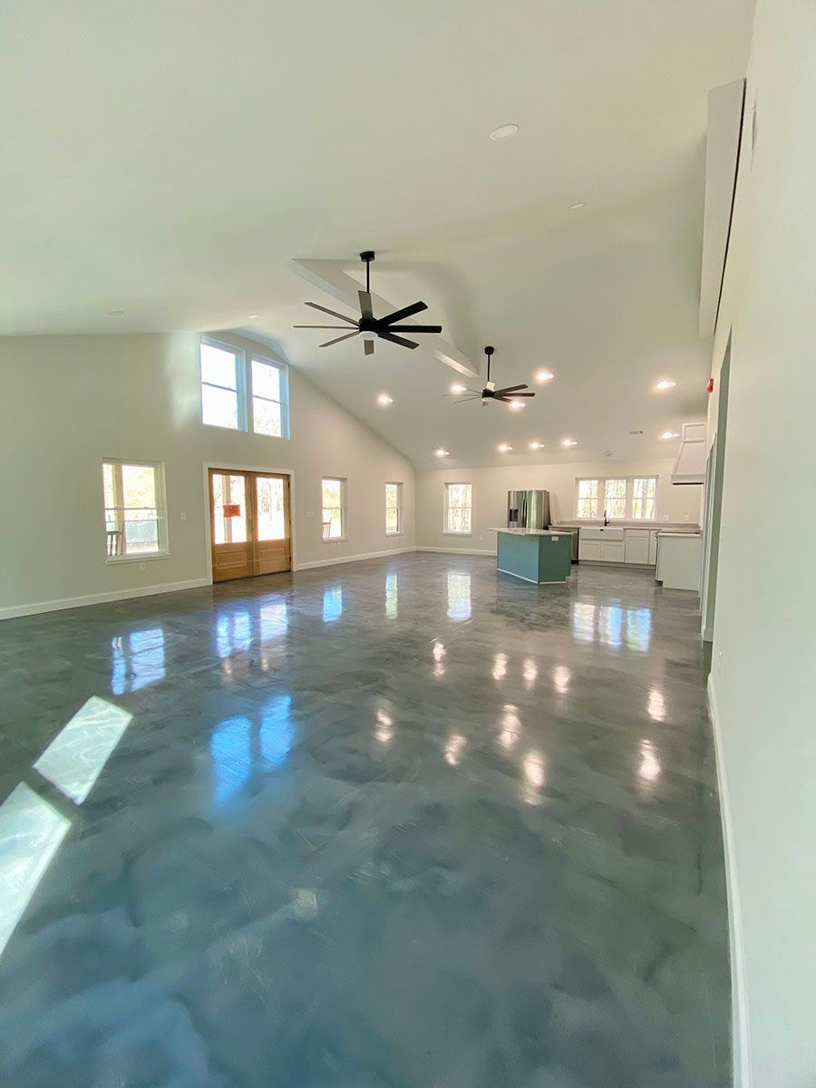 A spacious room with a ceiling fans and a beautiful floor