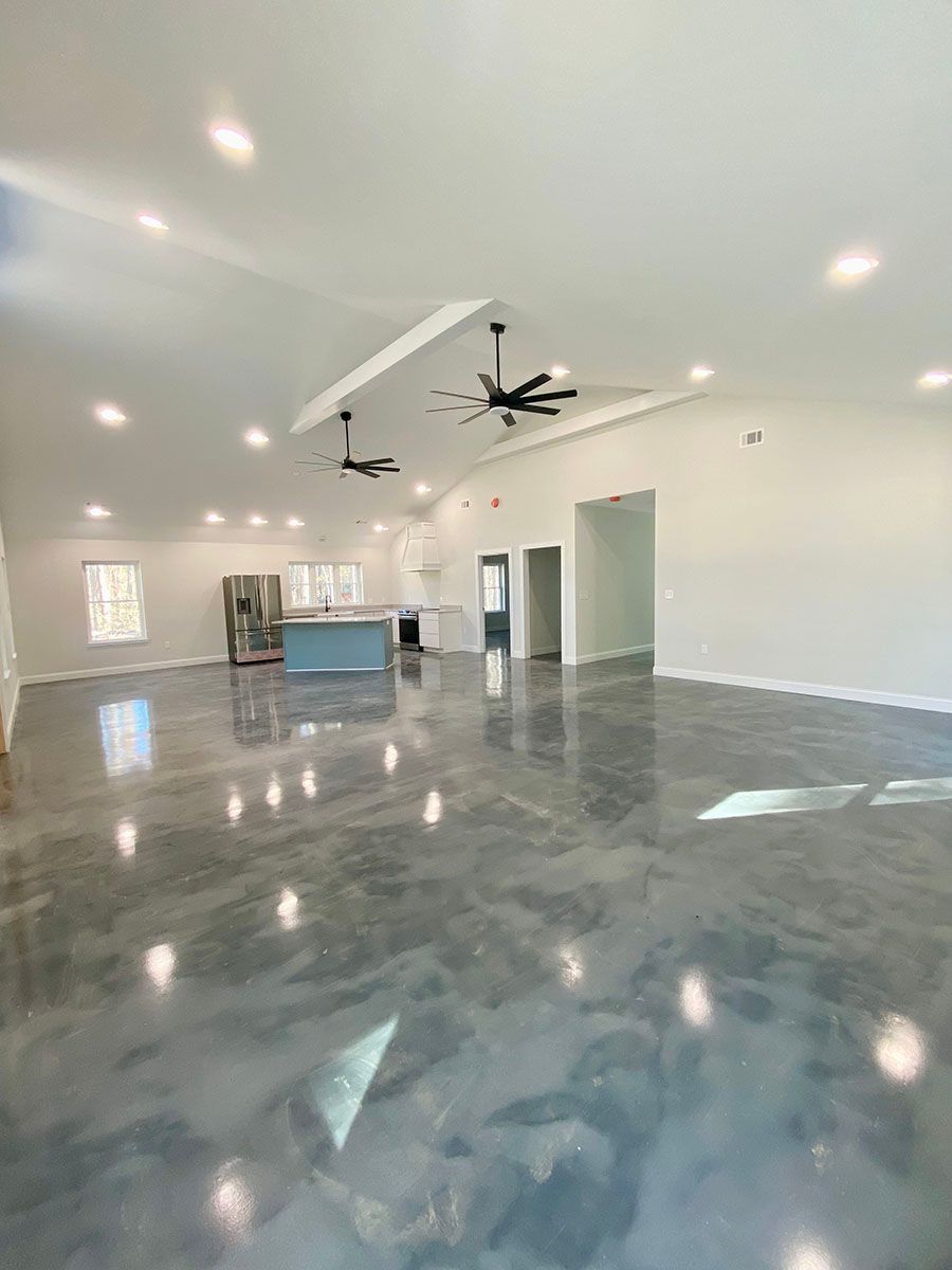 A spacious room with a shiny concrete floor