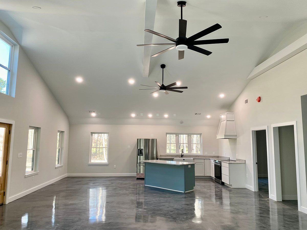 A kitchen with ceiling fans hanging from the ceiling