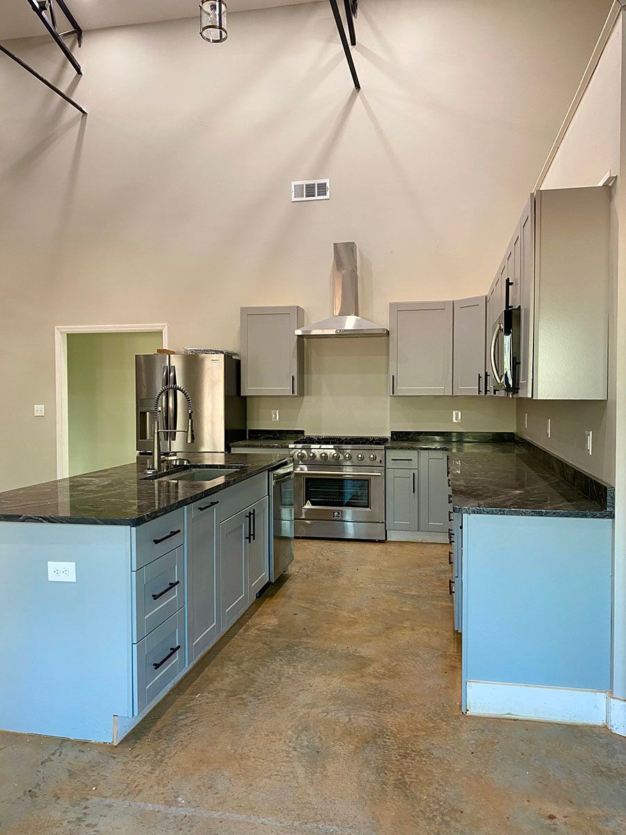 An empty kitchen with gray cabinets