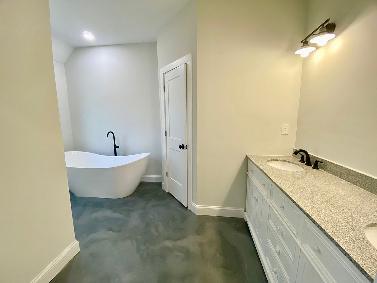 A bathroom with a bathtub and sinks