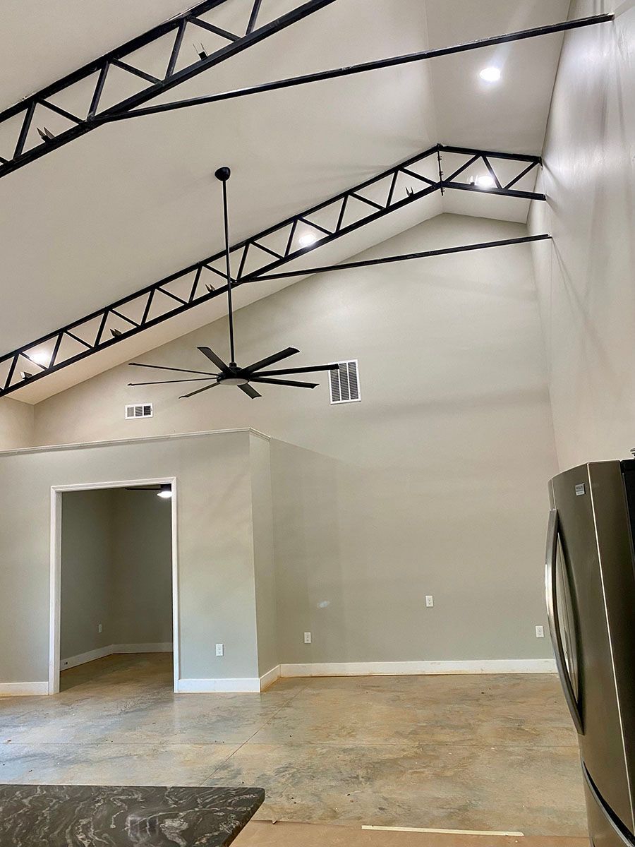 A large empty room with a vaulted ceiling