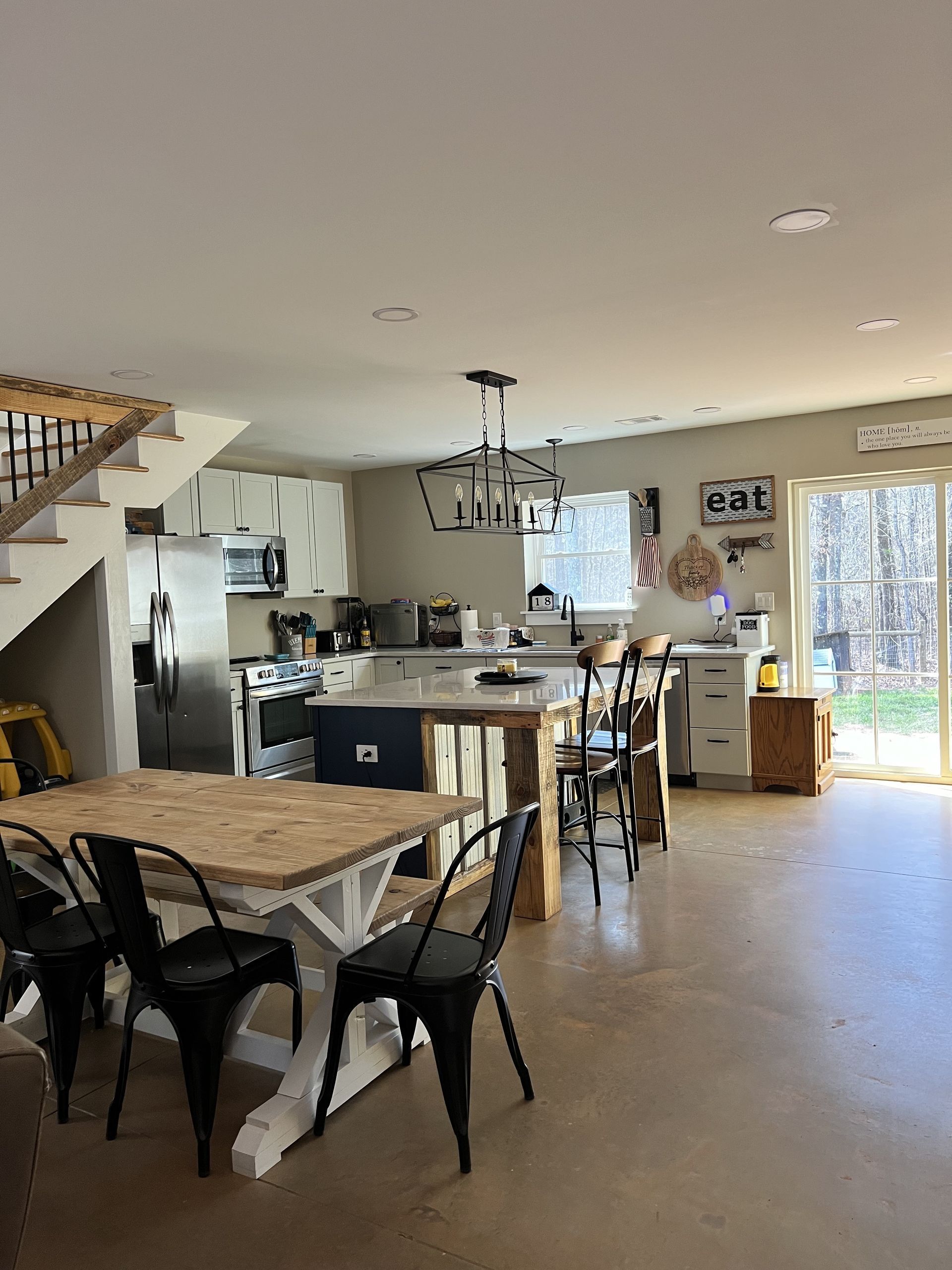 A kitchen with a table and chairs
