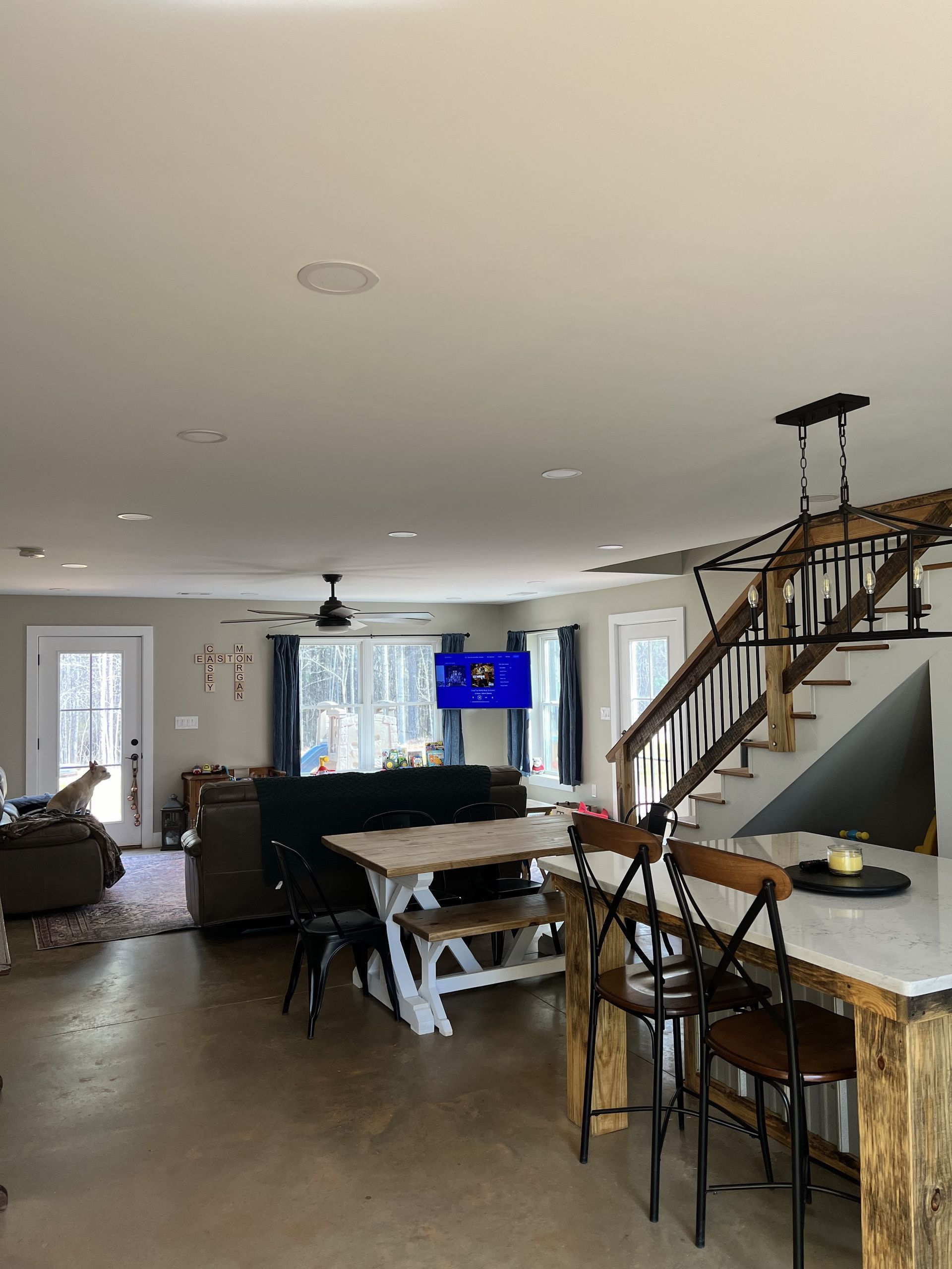 Living room with table, chairs, and stairs