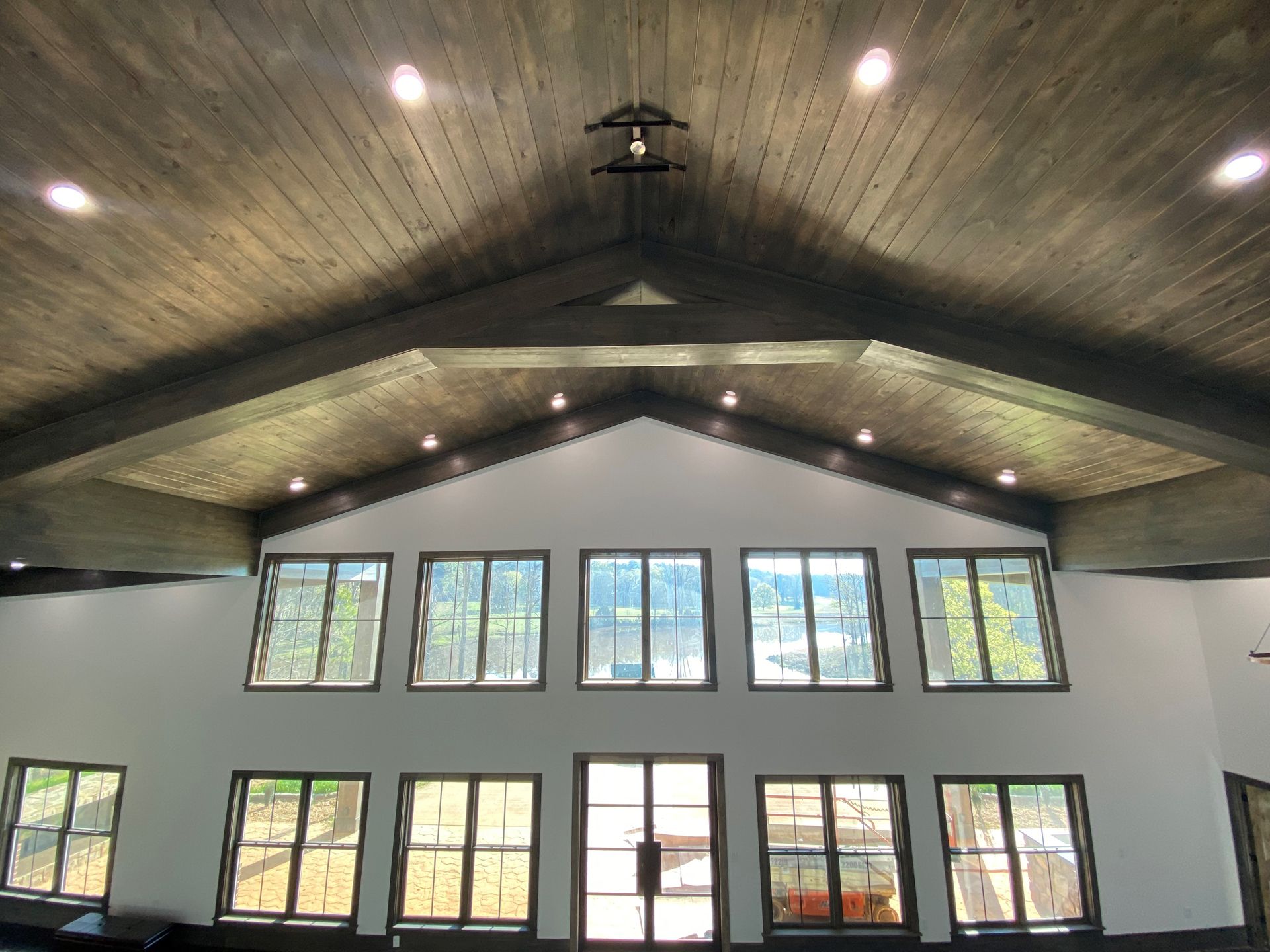 A large room with a vaulted ceiling and lots of windows