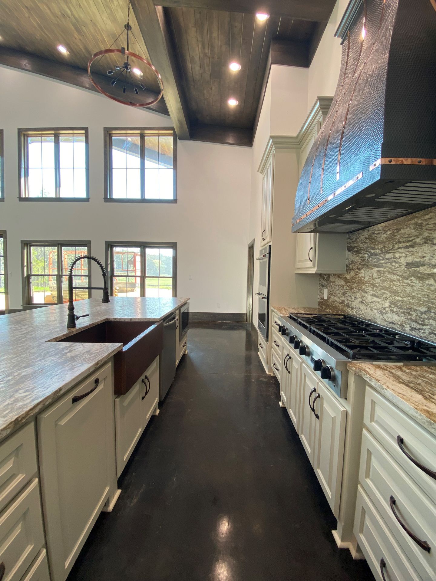A kitchen with a stove, sink, and dishwasher