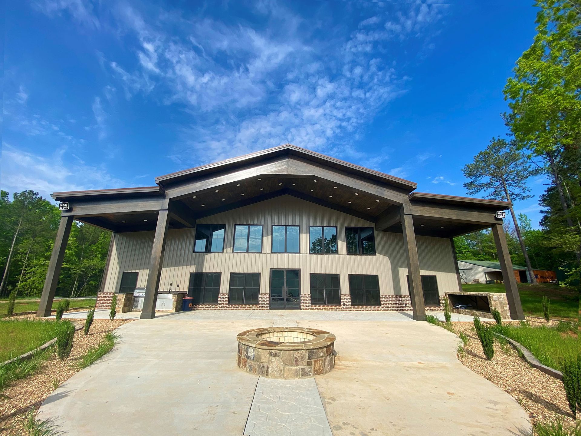A large house with a fire pit in front of it