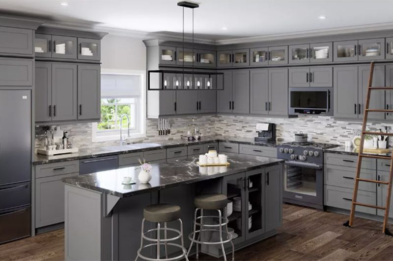 Modern gray kitchen with black granite island, stainless appliances, and a ladder near the cabinets.