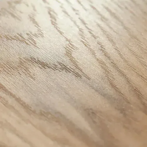 Close-up of light oak wood grain texture, showing detailed patterns and natural tones.