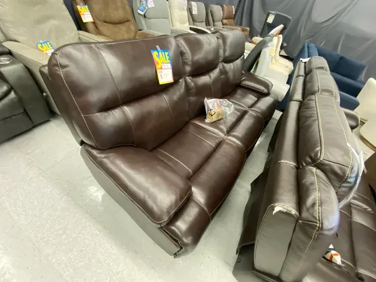 Brown leather recliner sofa in a store.