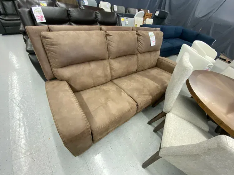 Brown recliner sofa in a showroom setting.