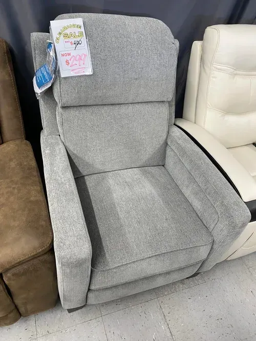 Gray upholstered recliner chair for sale in a store.