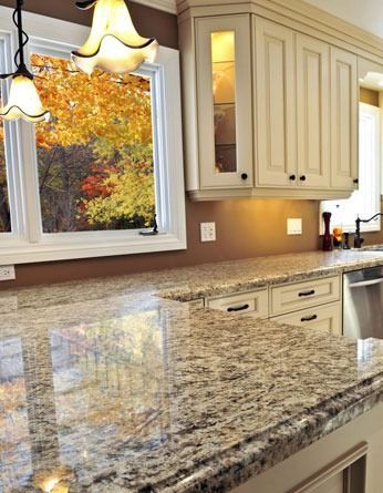 A kitchen with granite counter tops and stainless steel appliances