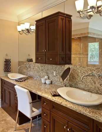 A bathroom with two sinks and a large mirror