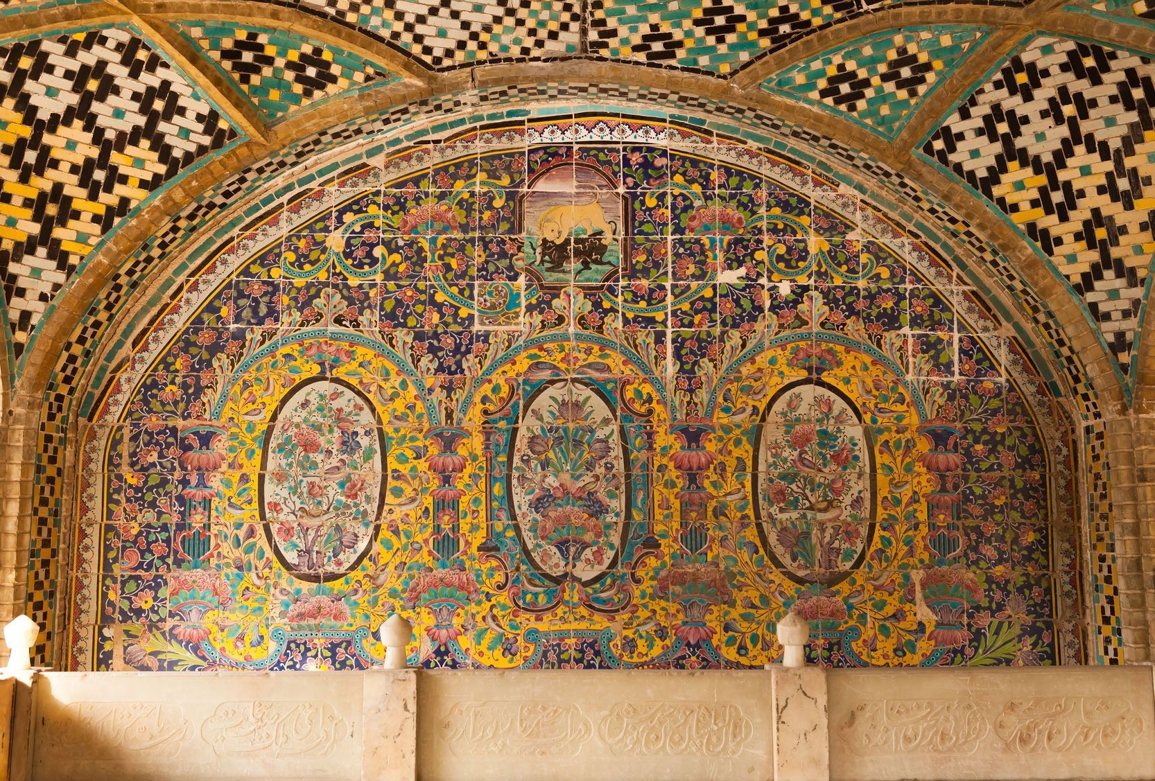 A colorful mosaic on the wall of a building.